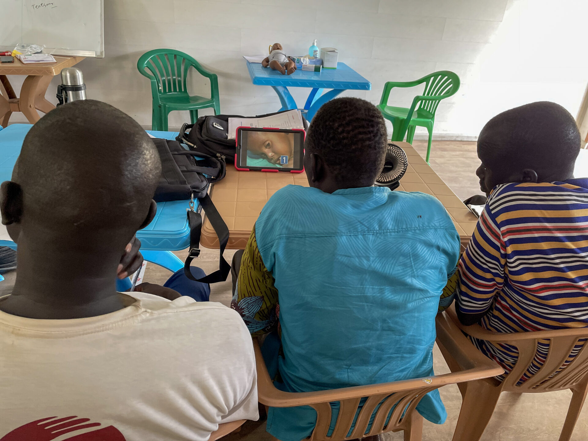 Participants of the OPD programme watching a learning video in a tablet